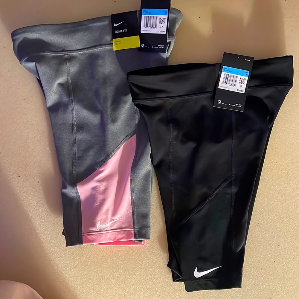Girls Med. Nike Dry, Tight Fit Training Shorts. 1-black pair, 1-gray/pink pair